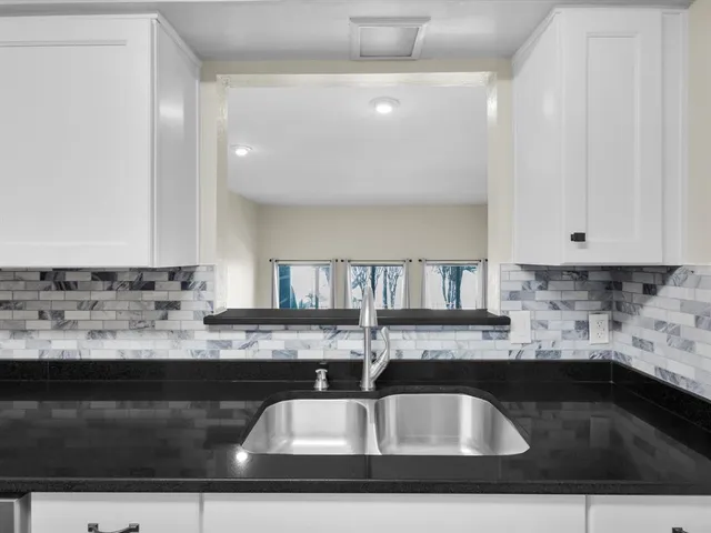 a kitchen with a refrigerator and window