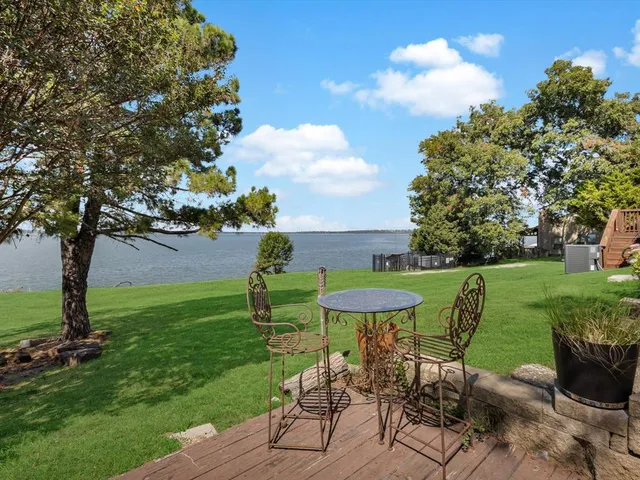 a balcony with wooden floor and fence