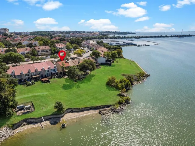 an aerial view of residential houses with outdoor space and lake view