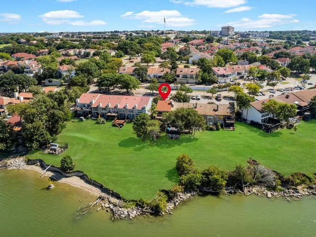 an aerial view of multiple houses with yard