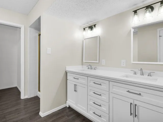 a view of a room with wooden floor fan and windows