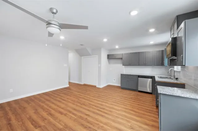 a large kitchen with kitchen island a sink stainless steel appliances and cabinets
