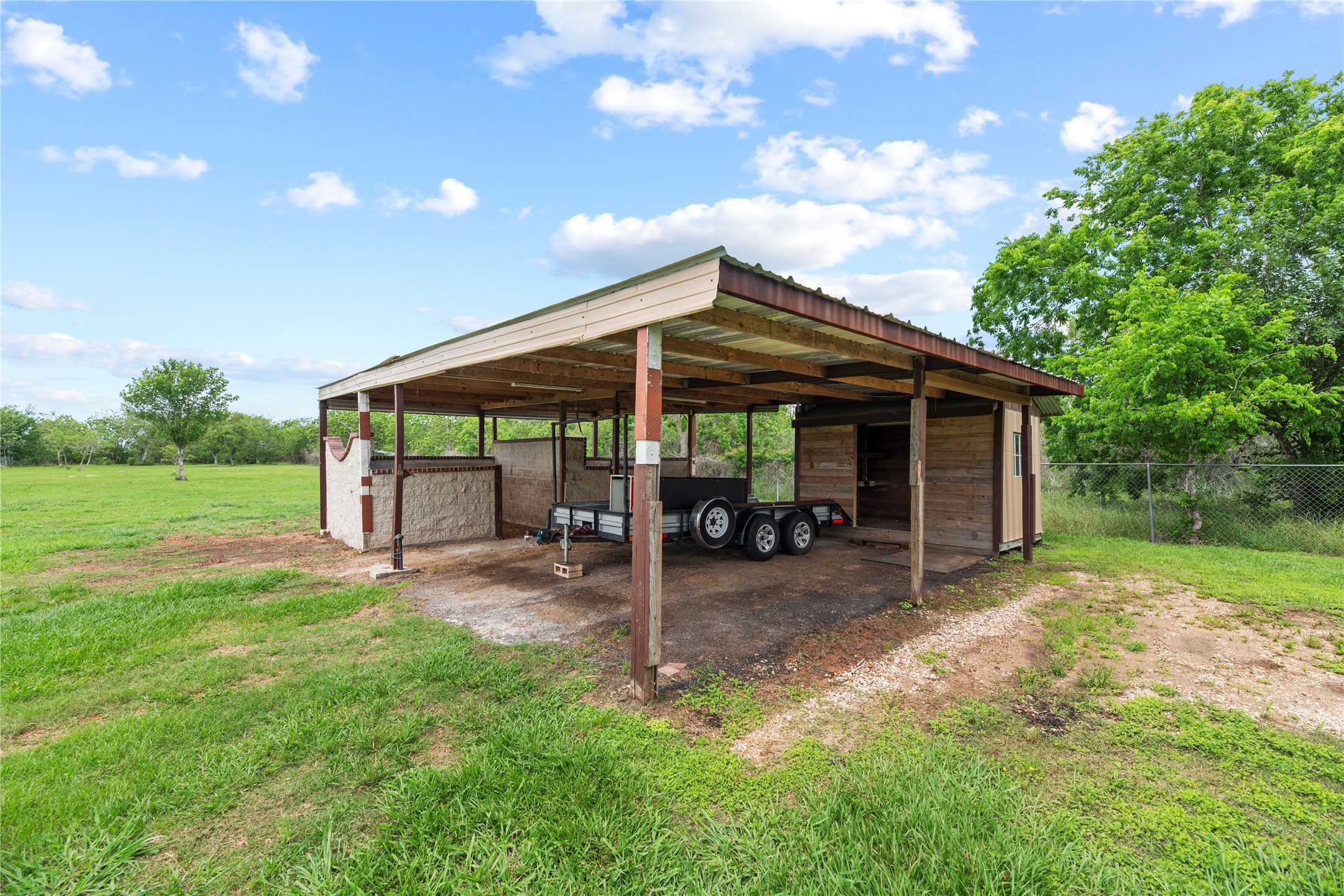 523 Moore Bar Road Rosenberg, TX 77471 - Photo 11 of 50 This property offers two horse stables, a feed storage shed and additional covered parking.