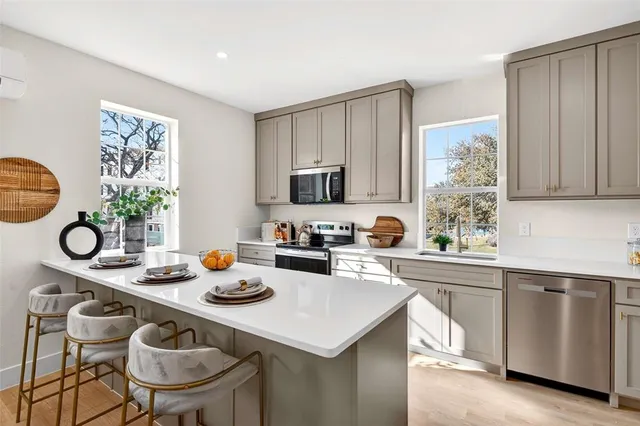 a kitchen with sink cabinets and microwave