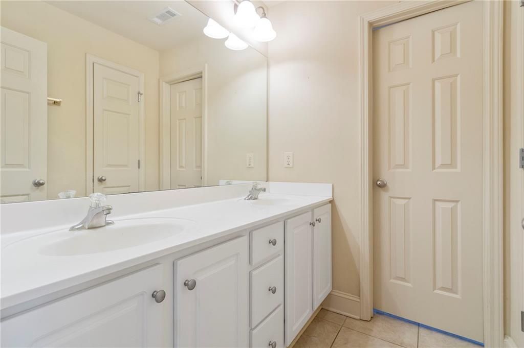 202 Davis Mill Road Ball Ground, GA 30107 - Photo 11 of 21 a bathroom with a double vanity sink and a mirror