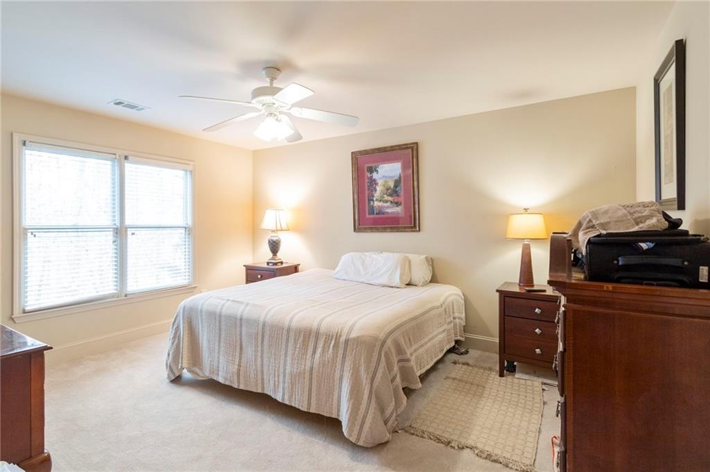 202 Davis Mill Road Ball Ground, GA 30107 - Photo 12 of 21 a bedroom with a bed and a chandelier
