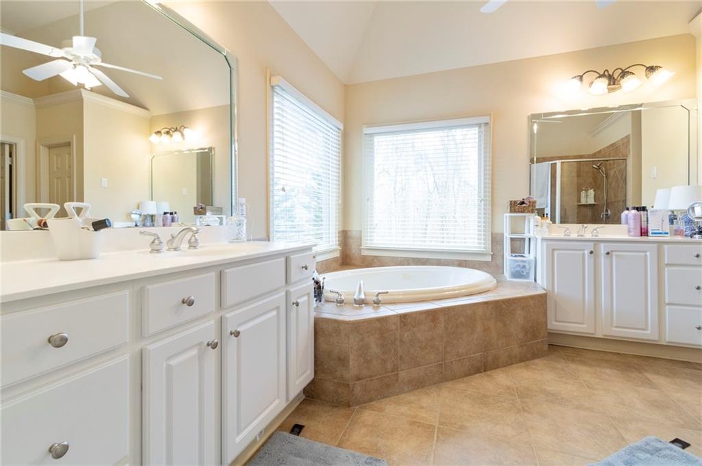 202 Davis Mill Road Ball Ground, GA 30107 - Photo 16 of 21 a spacious bathroom with a double vanity sink bathtub and next to a window