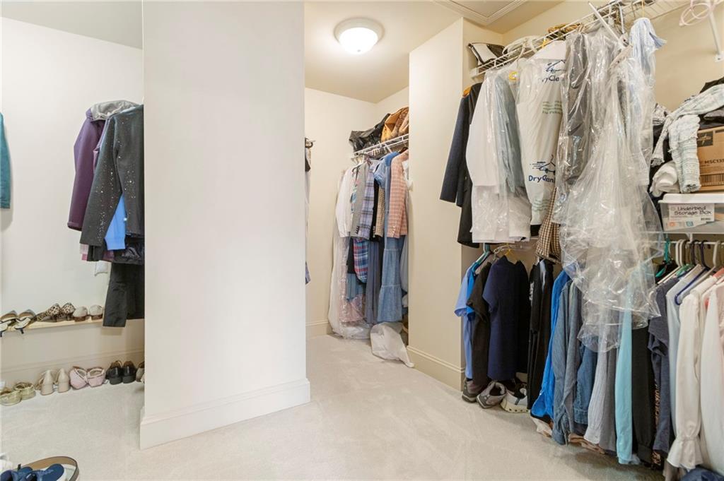 202 Davis Mill Road Ball Ground, GA 30107 - Photo 17 of 21 a view of walk in closet with clothes and shoes