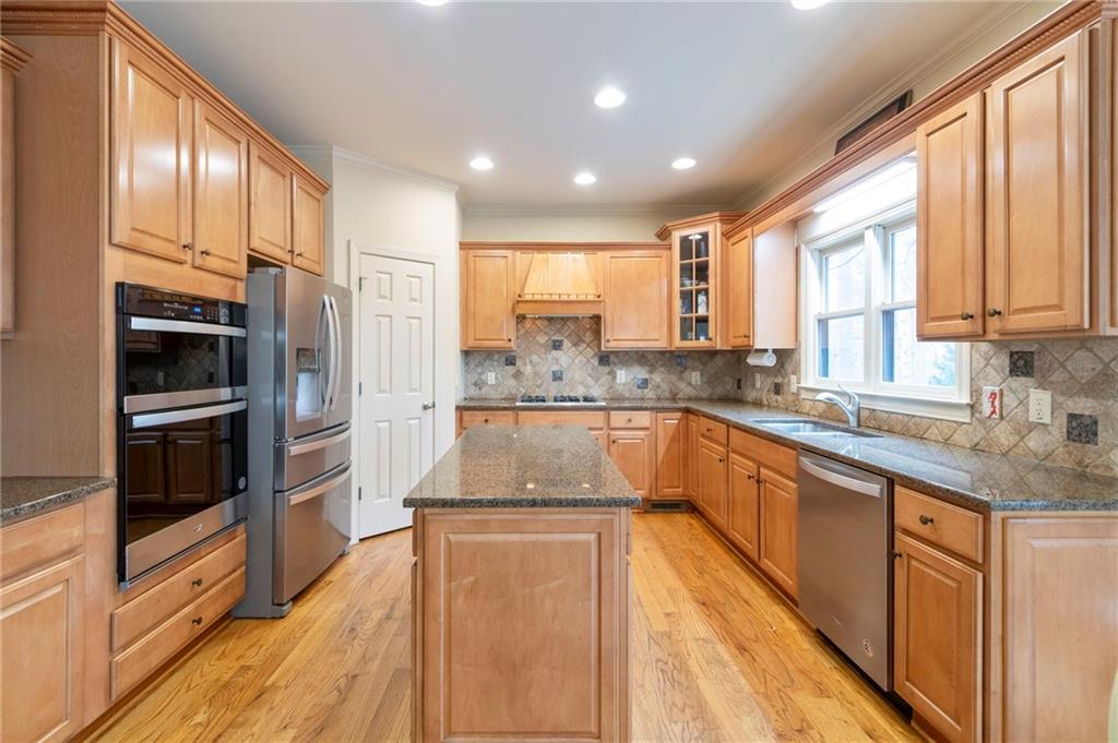 202 Davis Mill Road Ball Ground, GA 30107 - Photo 7 of 21 a large kitchen with stainless steel appliances granite countertop a stove a sink and a refrigerator