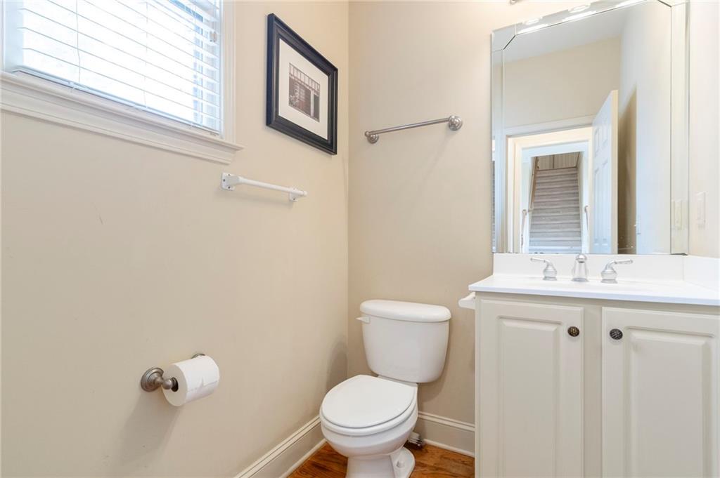 202 Davis Mill Road Ball Ground, GA 30107 - Photo 8 of 21 a bathroom with a toilet a sink and mirror
