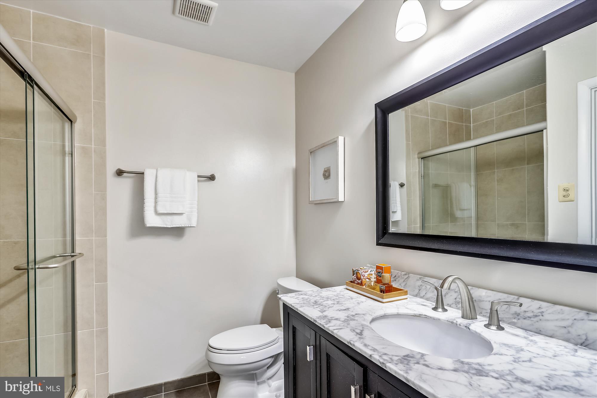 3005 Farm Road Alexandria, VA 22302 - Photo 25 of 59 a bathroom with a granite countertop sink a toilet and a mirror
