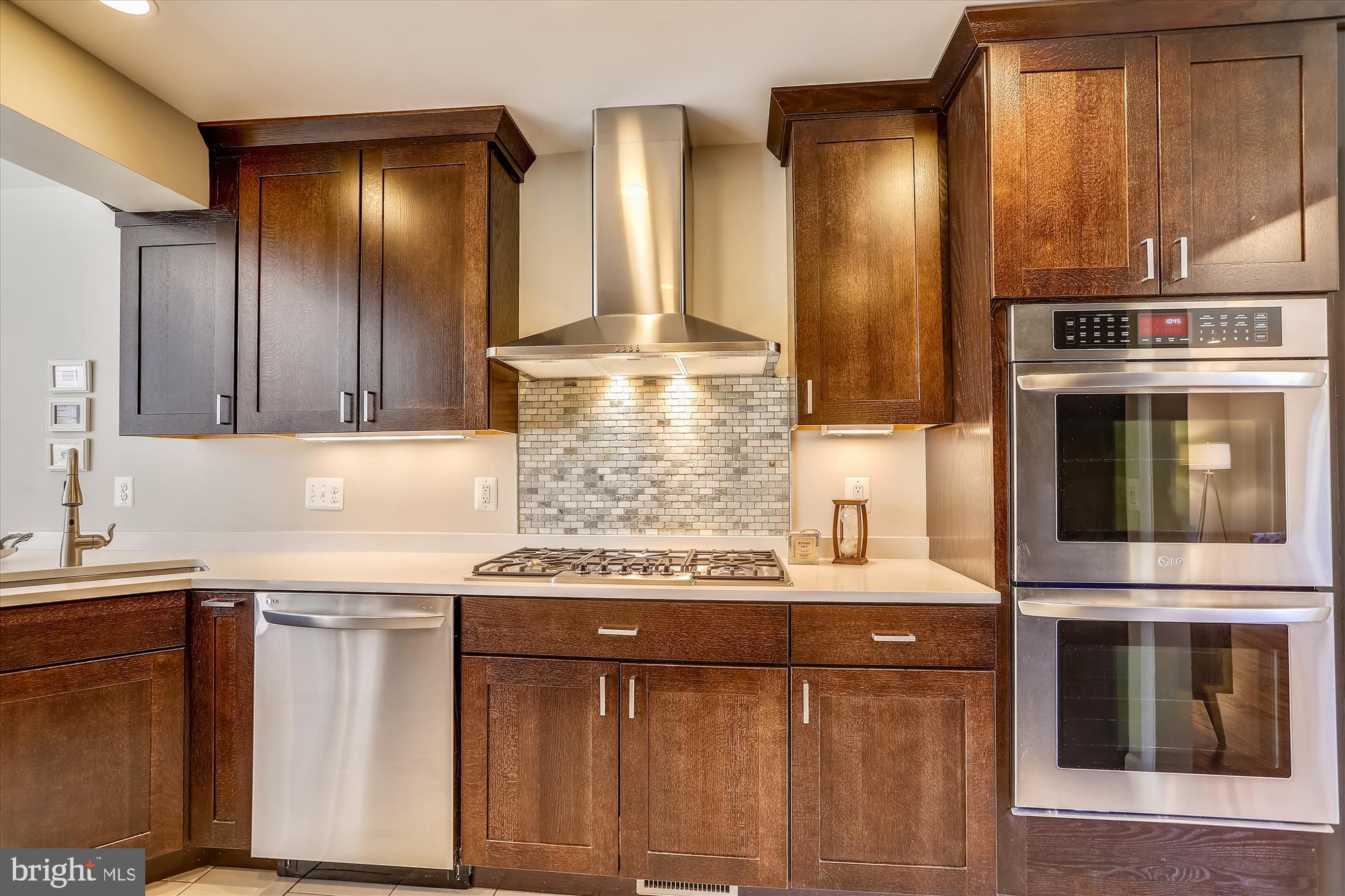 3005 Farm Road Alexandria, VA 22302 - Photo 9 of 59 a kitchen with stainless steel appliances wooden cabinets and a stove top oven
