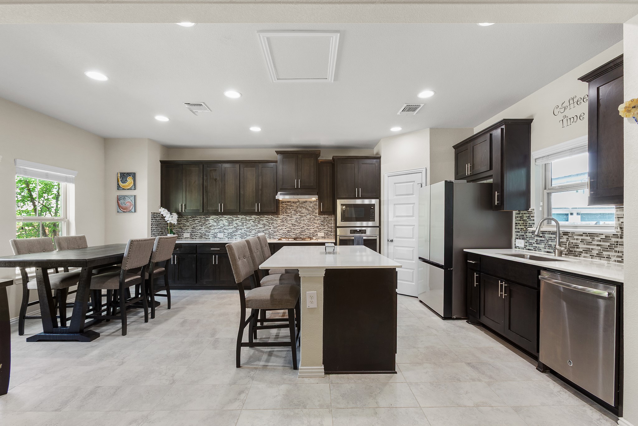 8709 Slater Drive Austin, TX 78747 - Photo 4 of 36 a kitchen with stainless steel appliances kitchen island granite countertop a table and chairs