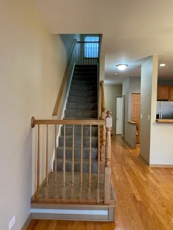 a view of entryway and hall with wooden floor
