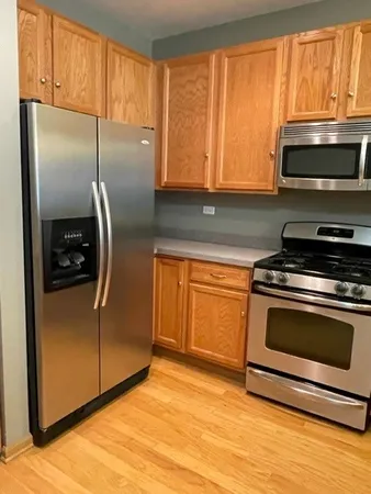 a kitchen with stainless steel appliances granite countertop a stove a microwave and a refrigerator