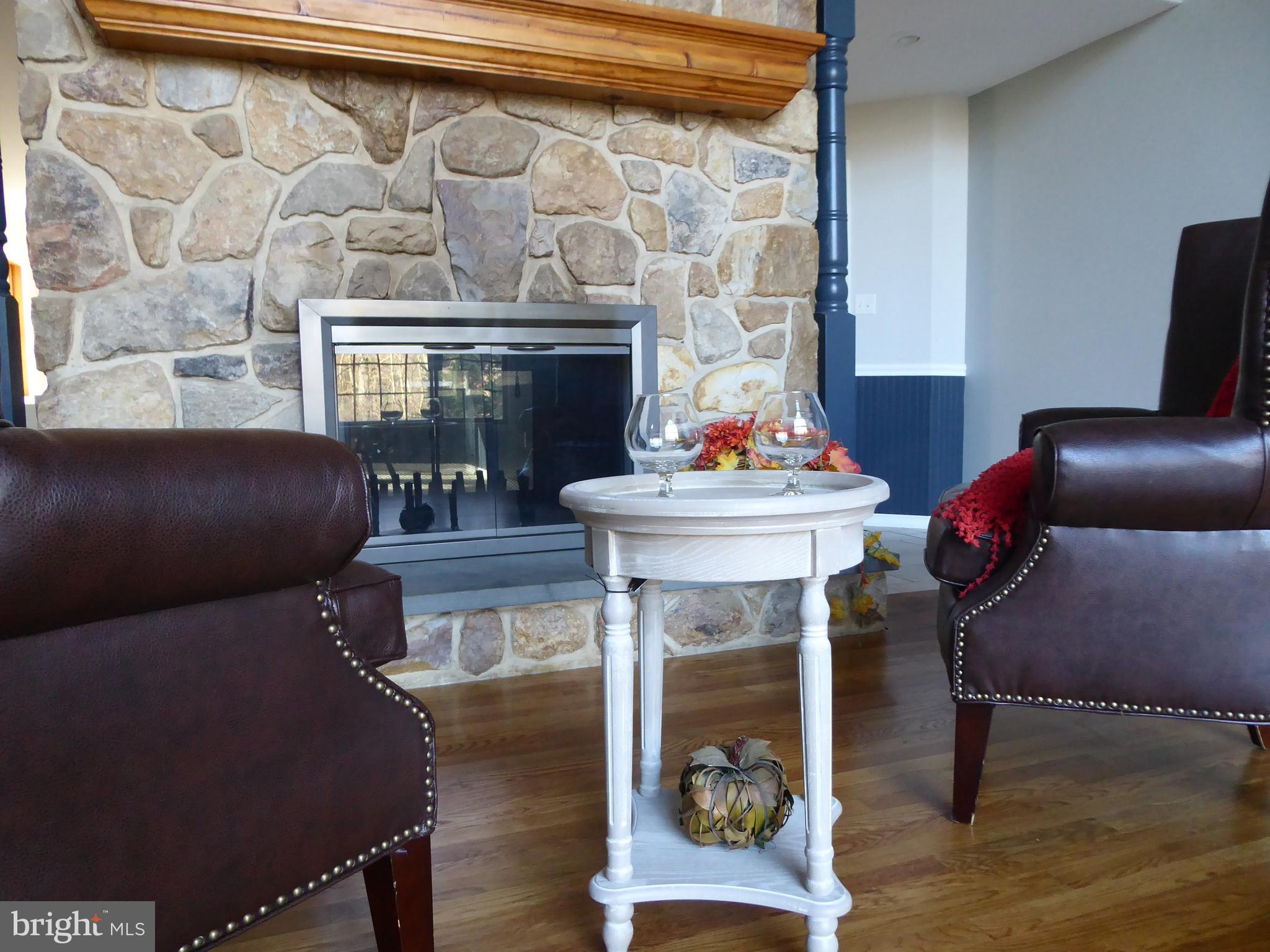 135 Watson Mill Road Landenberg, PA 19350 - Photo 9 of 56 Double sided stone fireplace-great room side