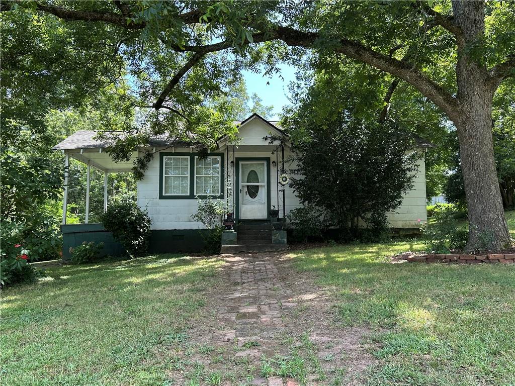 4911 Penfield Road Union Point, GA 30669 - Photo 1 of 1 front view of a house with a yard