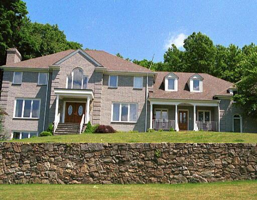 667 Hunting Ridge Road Stamford, CT 06903 - Photo 1 of 1 a front view of a house with a garden