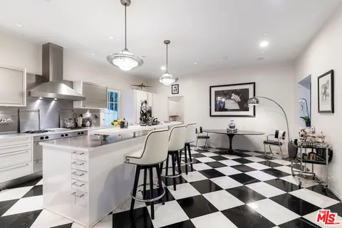 a kitchen with a sink a counter top space and stainless steel appliances