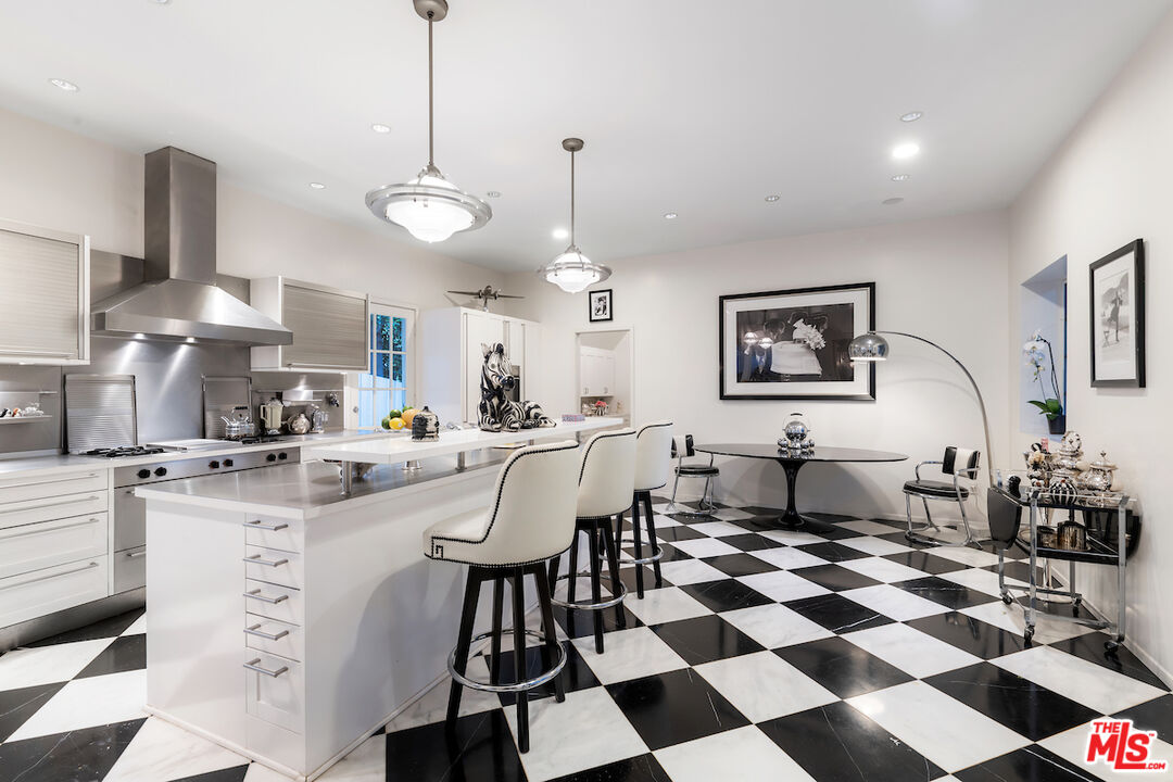601 Woodruff Avenue Los Angeles, CA 90024 - Photo 12 of 39 a kitchen with stainless steel appliances granite countertop a sink a stove a refrigerator and island