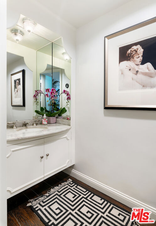 601 Woodruff Avenue Los Angeles, CA 90024 - Photo 16 of 39 a bathroom with a sink and a mirror