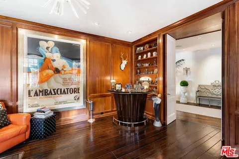a living room with furniture fireplace and a large window