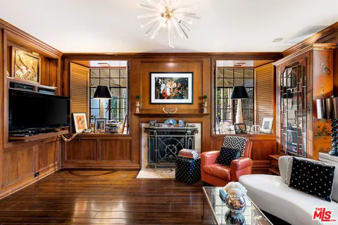 a view of a living room with furniture and a fireplace