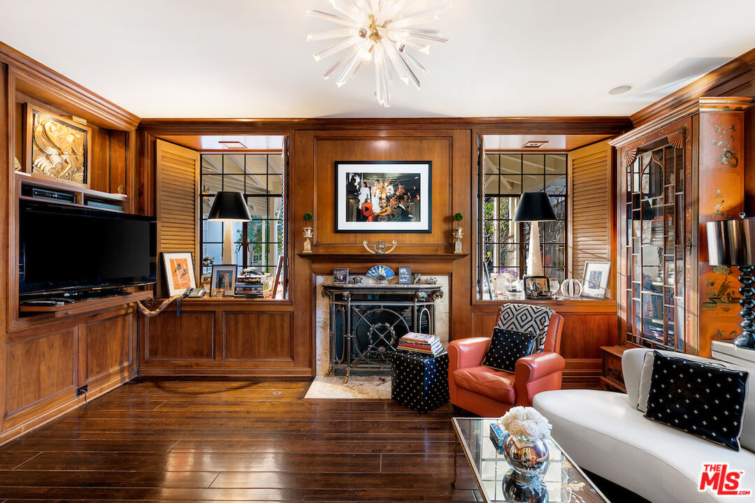 601 Woodruff Avenue Los Angeles, CA 90024 - Photo 19 of 39 a living room with furniture a flat screen tv and a fireplace