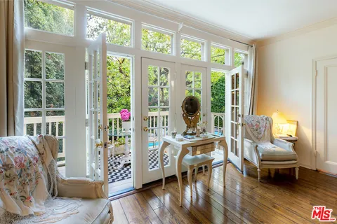 a very nice looking room with a large window and furniture