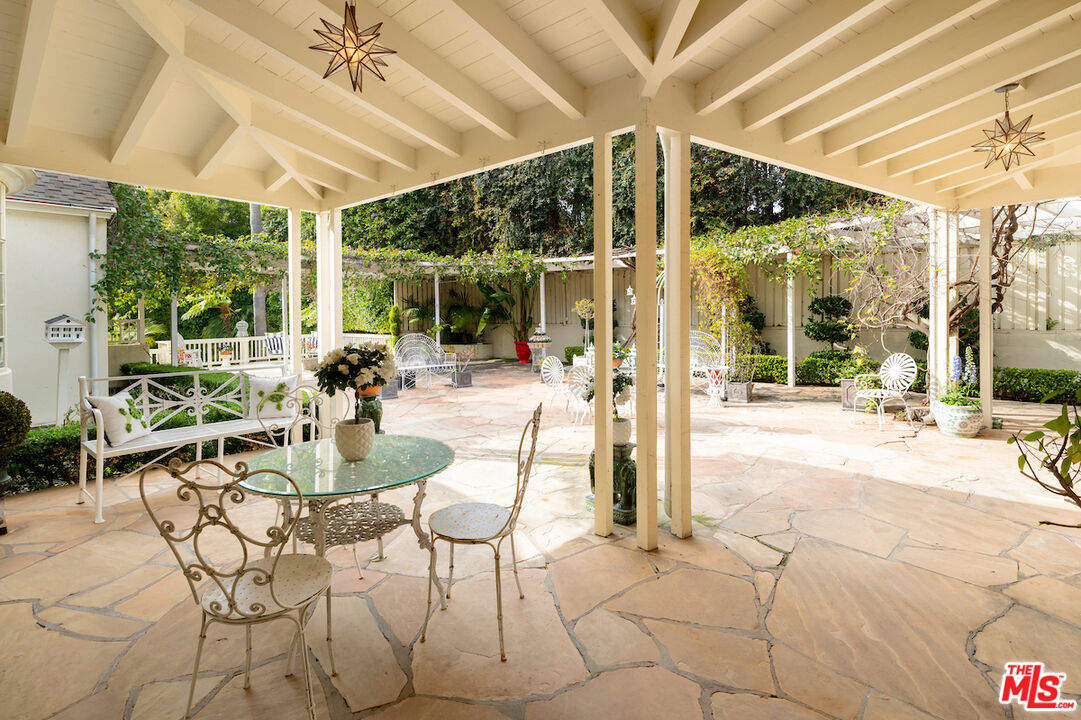 601 Woodruff Avenue Los Angeles, CA 90024 - Photo 29 of 39 a view of a patio with a table and chairs under an umbrella