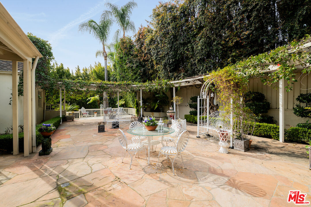 601 Woodruff Avenue Los Angeles, CA 90024 - Photo 39 of 39 a view of a patio with table and chairs potted plants and large tree