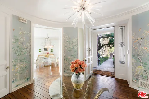 a living room with fireplace furniture and a wooden floor