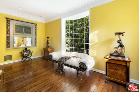 a living room with fireplace furniture and a floor to ceiling window
