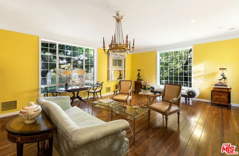a view of a dining room with furniture wooden floor and chandelier