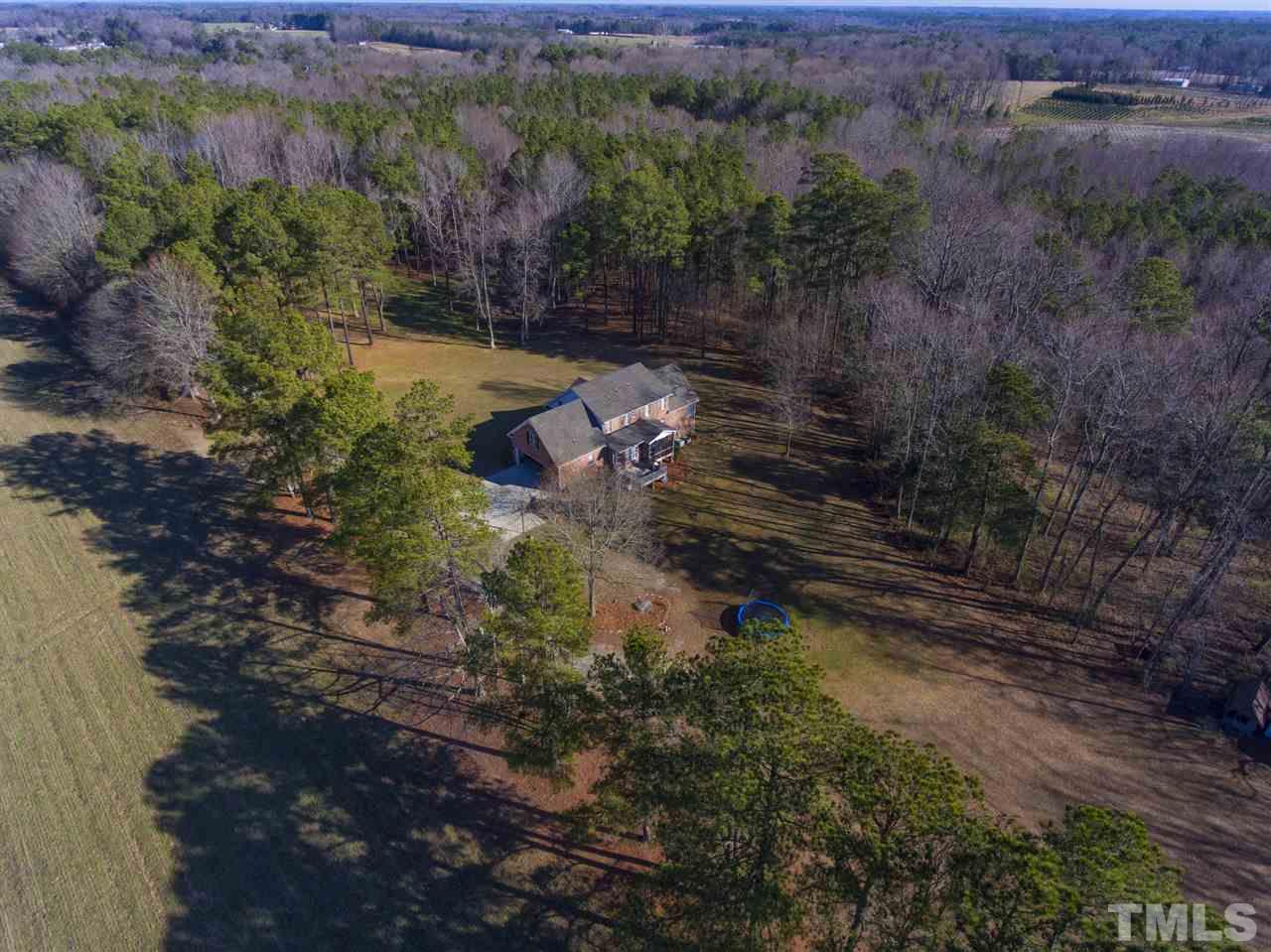 6407 Wimberly Road Willow Spring, NC 27592 - Photo 1 of 25 a backyard of a house with lots of green space