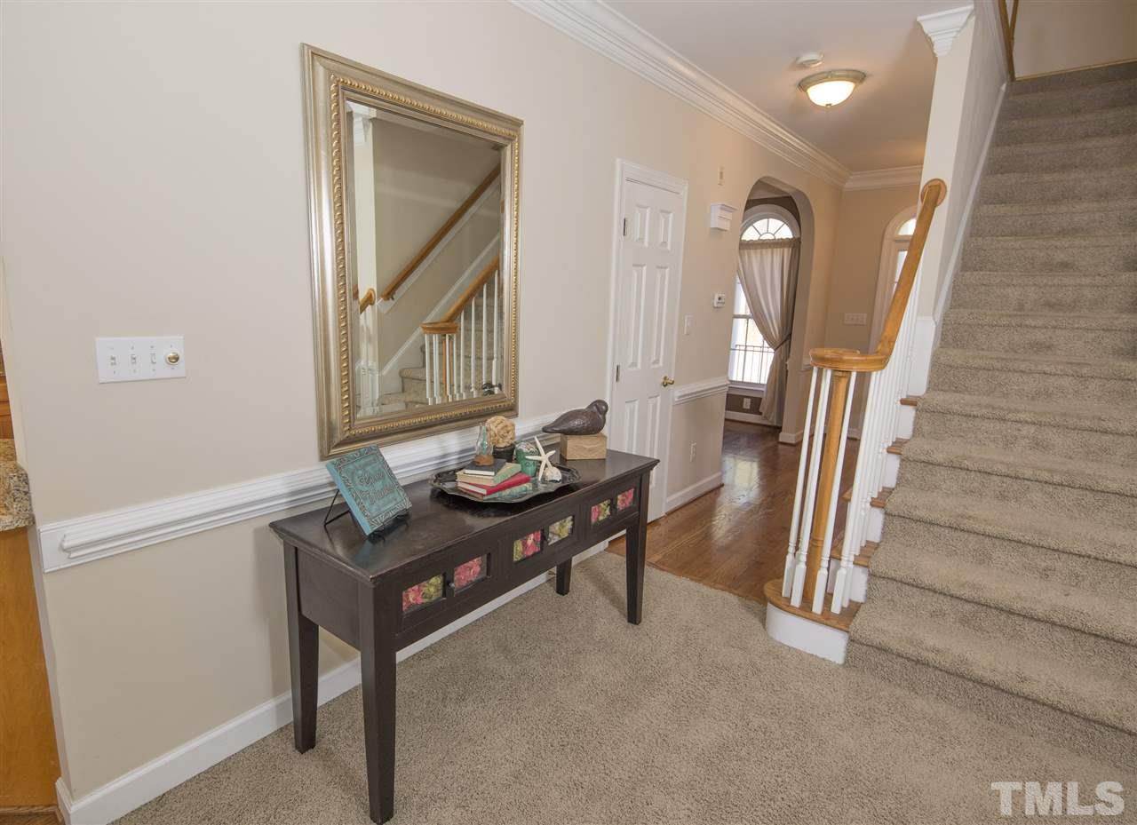 6407 Wimberly Road Willow Spring, NC 27592 - Photo 12 of 25 a view of a hallway to a livingroom with furniture and wooden floor
