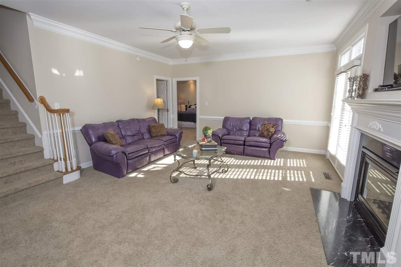 6407 Wimberly Road Willow Spring, NC 27592 - Photo 14 of 25 a living room with furniture and a fireplace