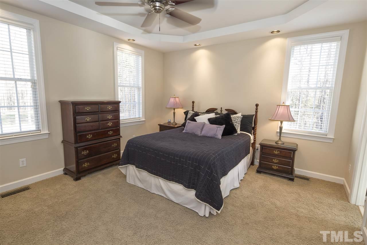 6407 Wimberly Road Willow Spring, NC 27592 - Photo 15 of 25 a bedroom with a bed a dresser and a window