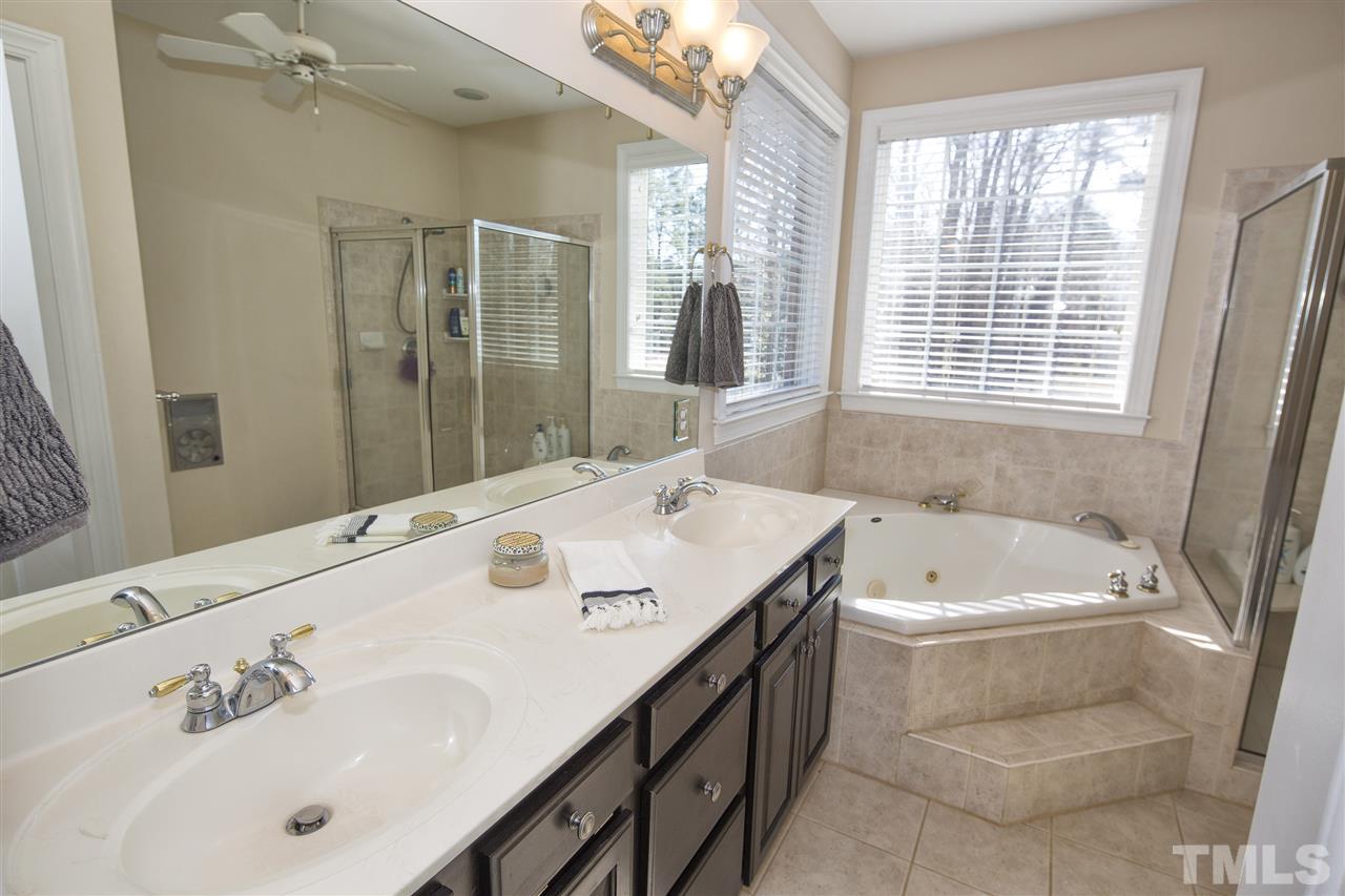 6407 Wimberly Road Willow Spring, NC 27592 - Photo 16 of 25 a spacious bathroom with a tub sink and mirror