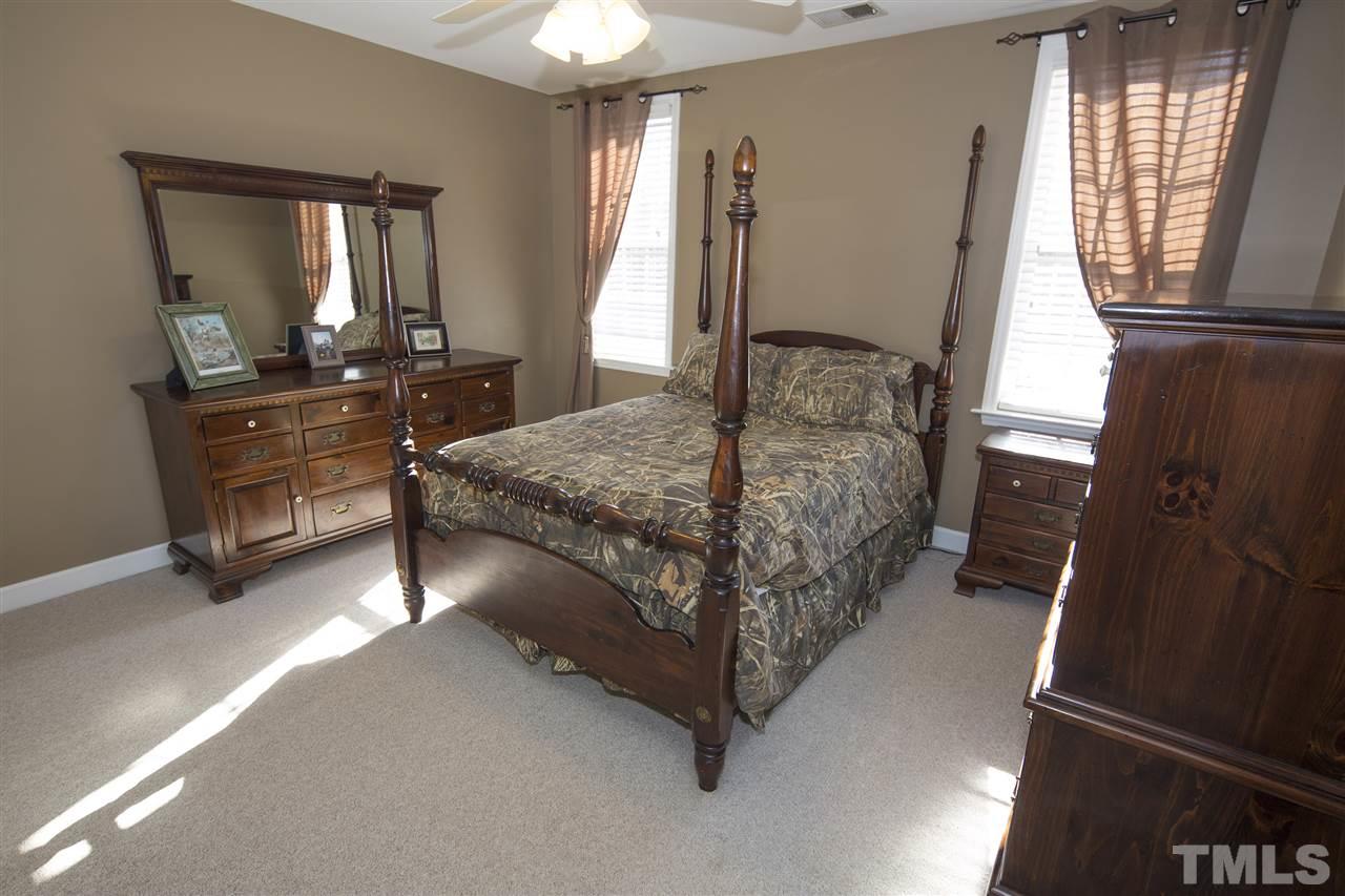 6407 Wimberly Road Willow Spring, NC 27592 - Photo 18 of 25 a bedroom with a bed window and dresser