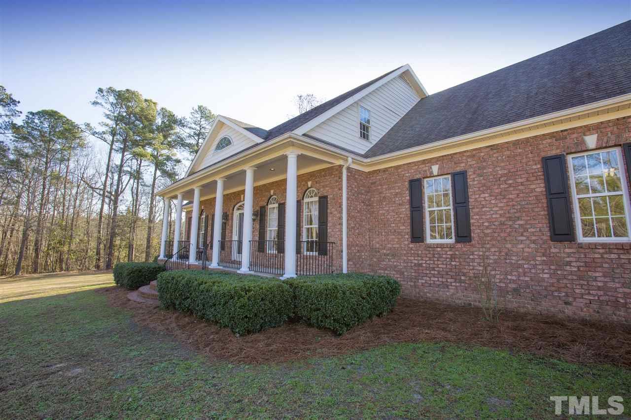 6407 Wimberly Road Willow Spring, NC 27592 - Photo 3 of 25 a front view of a house with garden