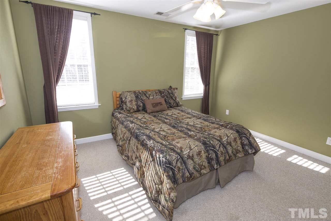 6407 Wimberly Road Willow Spring, NC 27592 - Photo 21 of 25 a bedroom with a bed and a window