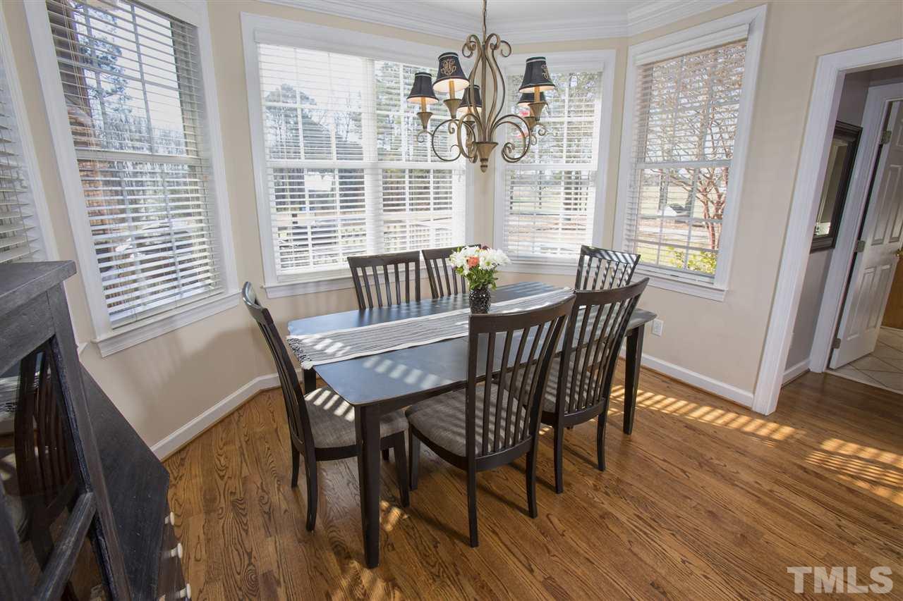 6407 Wimberly Road Willow Spring, NC 27592 - Photo 10 of 25 a view of a dining room with furniture wooden floor and a chandelier