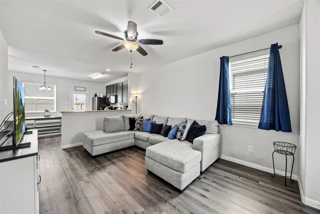 a living room with furniture and a large mirror