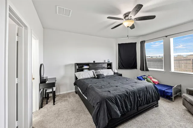 a bedroom with a large bed and a flat screen tv