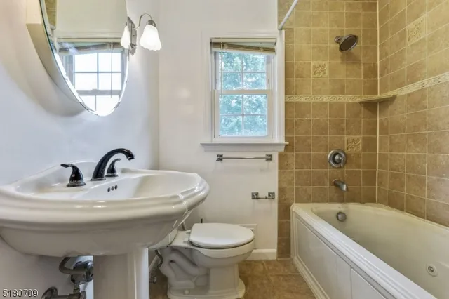 a bathroom with a sink a toilet and bathtub