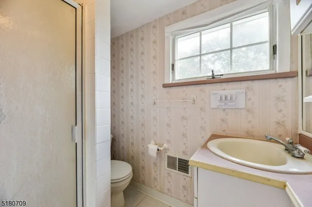 a white toilet sitting next to a bathroom sink