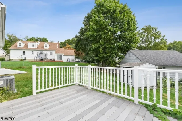 a view of a wooden fence and a yard