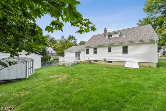 a view of a house with backyard and garden