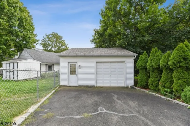 a view of a house with a yard and garage